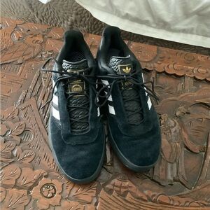 Adidas black suede PUIG sneaker.
